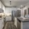 Spacious and well lit kitchen with wood flooring and stainless steel appliances