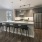 Spacious and well lit kitchen with wood flooring and stainless steel appliances
