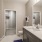 Large well lit bathroom with white accents 