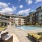 Large sparkling blue pool with a large pool deck and lounge chairs