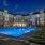 Large sparkling blue pool with a large pool deck and lounge chairs