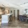 Spacious and well lit kitchen with wood flooring and stainless steel appliances